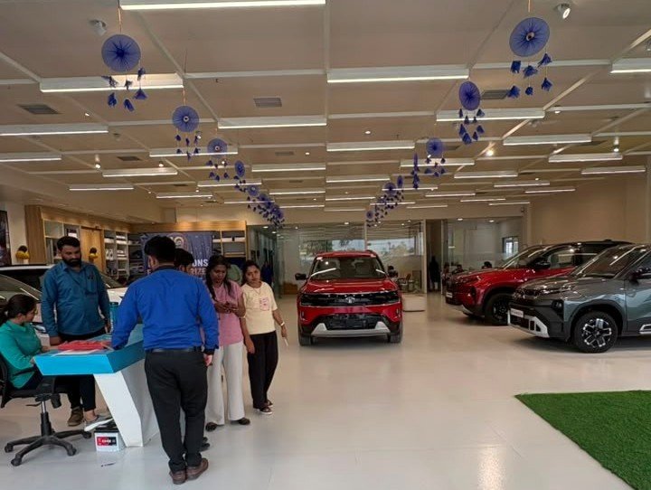 Customers inside a Kamu Motors showroom